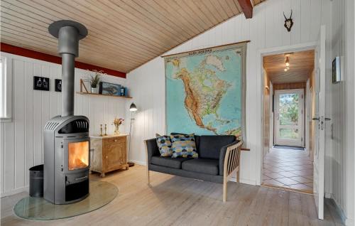 a living room with a fireplace and a couch at 4 Bedroom Beautiful Home In Hvide Sande in Hvide Sande