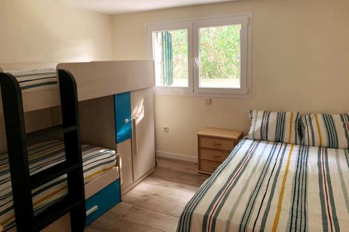 a bedroom with two bunk beds and a window at La Casa del Lago in Navas del Rey