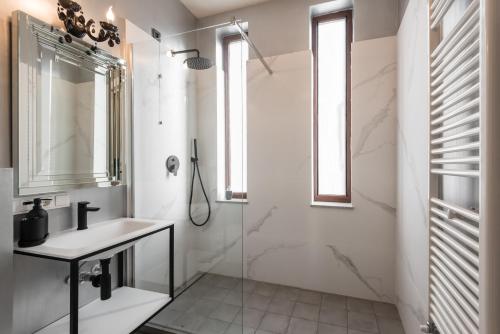 a bathroom with a sink and a shower at HIGHLINE DOWNTOWN ApartHotel OLDTOWN UNIRII SQUARE in Bucharest