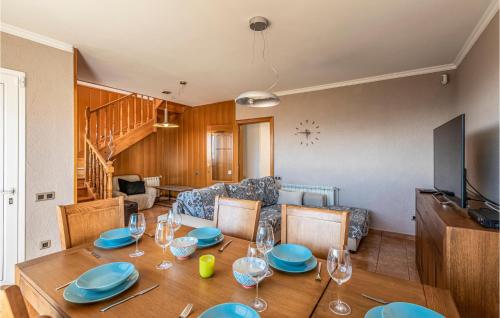 a dining room with a table and a couch at Gorgeous Home In Sant Cebrià De Vallalt in Sant Cebrià de Vallalta
