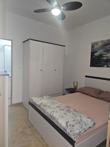 a bedroom with a bed and a ceiling fan at Villa Marko 3 Bedrooms apartment in Pula