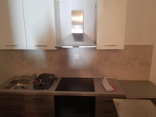 a kitchen with a sink and a stove top oven at Villa Marko 3 Bedrooms apartment in Pula