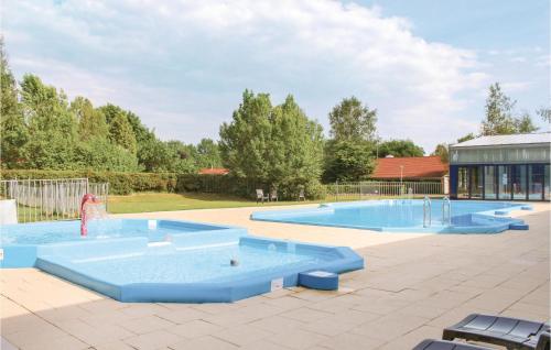 a swimming pool with two large blue pools at Awesome Home In Gramsbergen With Wifi in Gramsbergen