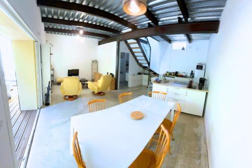 a kitchen and dining room with a white table and chairs at Grand Loft Lumineux - Gare St Charles 10 MIN in Marseille