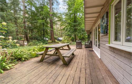 a wooden deck with a picnic table on the side of a house at 1 Bedroom Stunning Home In Laag-Soeren in Laag-Soeren