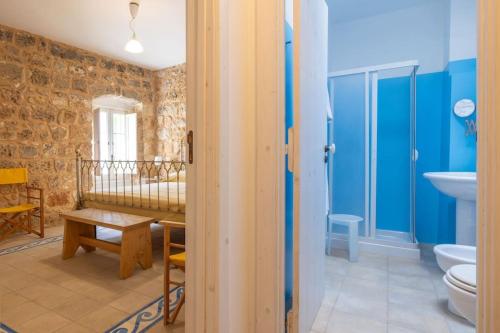 a room with a bathroom with a toilet and a sink at Appartamento Casetta Salentina in Felline