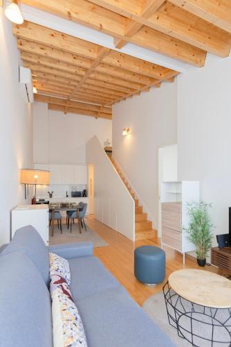 a living room with a blue couch and a table at Liiiving in Porto - City View Apartments in Porto