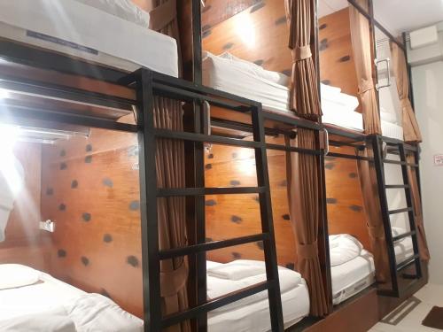 a group of bunk beds in a room at The 8 Factory Hotel Phitsanulok in Phitsanulok
