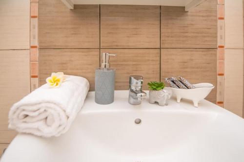 ein Badezimmer mit einem Waschbecken und einem Handtuch auf der Ablage in der Unterkunft Ntina's Apartment in Rhodos (Stadt)