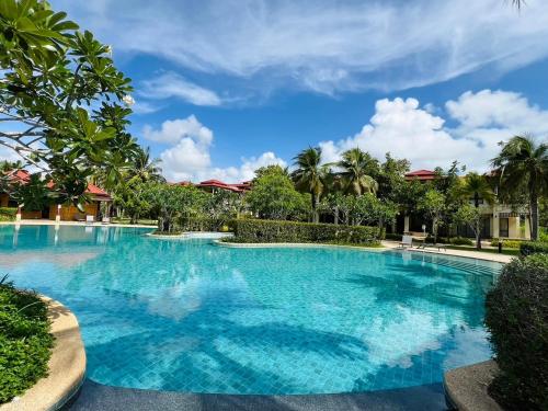a large swimming pool with blue water at Laguna Village by RESAVA in Layan Beach