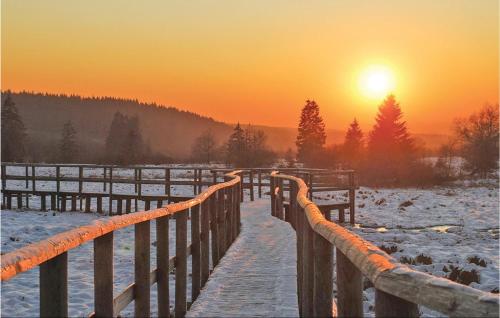 a fence in the snow with the sunset in the background at Hünningen in Bullange