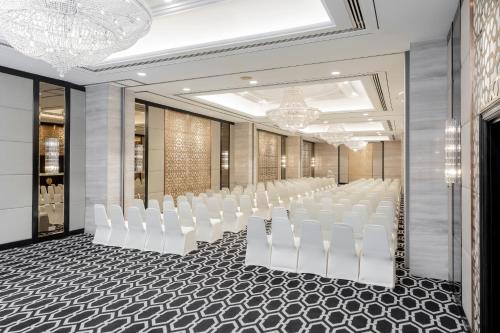 a row of white chairs in a conference room at Meliá Kuala Lumpur in Kuala Lumpur