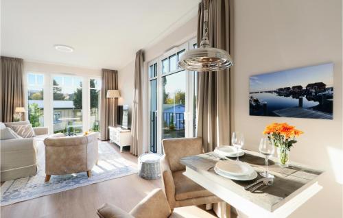 a living room with a table and a dining room at Baltischer Hof Apartment 31 in Boltenhagen
