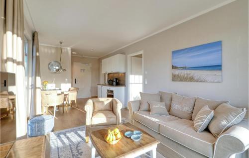 a living room with a couch and a table at Baltischer Hof Apartment 31 in Boltenhagen