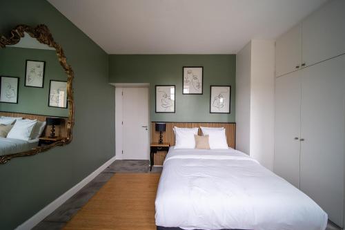 a bedroom with a large bed and a mirror at Hôtel Château Schengen in Schengen