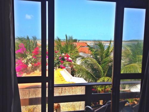 a view of the beach from a window at Pousada Recanto do Sal in Salinópolis