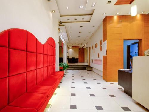 a red bench in the hallway of a building at Shijia Inn On the Bund in Shanghai