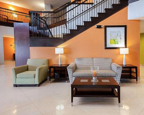 a lobby with two chairs and a couch and a table at Quality Suites in Sulphur