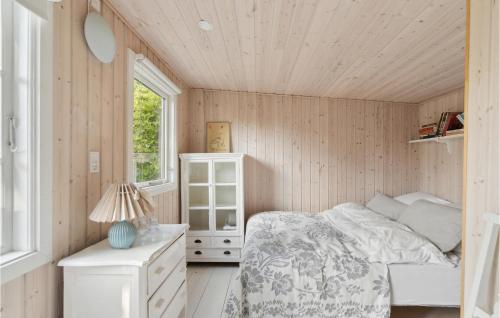 a small bedroom with a bed and a window at Awesome Home In Hornbæk With Wifi in Hornbæk