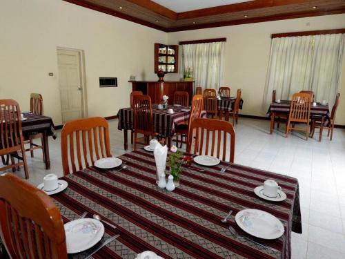 a dining room with a table and chairs and a table and chairsktop at Kyaw Hotel Bagan in Thiyipyitsaya