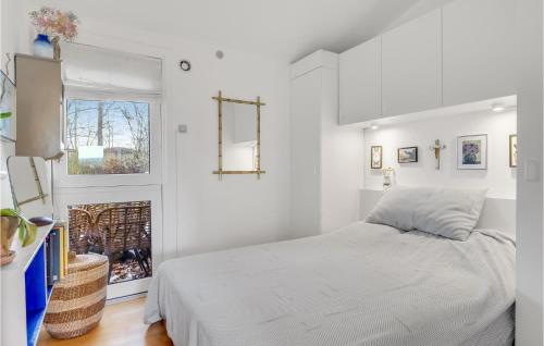 a white bedroom with a bed and a window at Amazing Home In Vejby With Wifi in Vejby