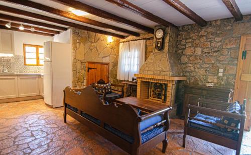 a room with a fireplace and a bed and a table at Kefalonian Luxury Villas in Kástron