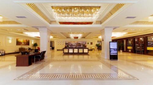 a large lobby with a chandelier in a building at Chengdu Haotian Guotai Hotel in Chengdu