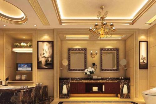 a bathroom with a vanity and a chandelier at Xin Sheng Da Hong Sheng International Hotel in Kunming