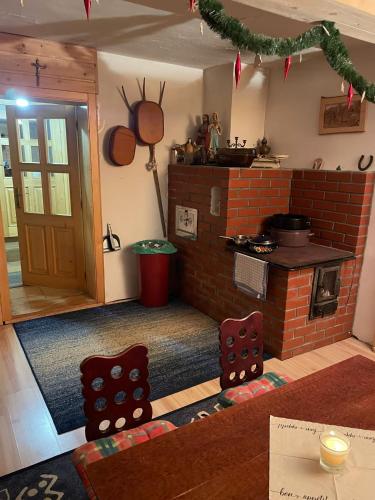 a kitchen with a stove and a brick oven at Chalupa Zákopčie in Zákopčie