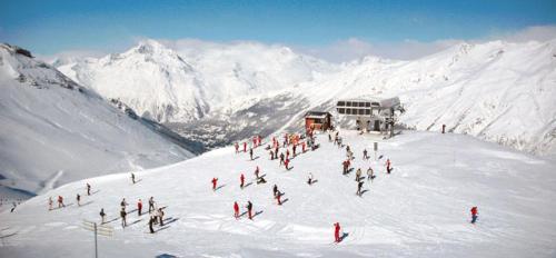 a group of people standing on a snow covered mountain at VVF Val-Cenis Haute-Maurienne in Lanslevillard