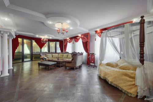 a bedroom with a bed and a living room at Hotel Alberia in Pyatigorsk