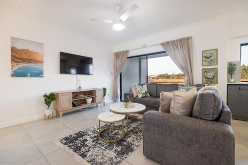 a living room with a couch and a table at Ballito Village Luxury Apartments in Ballito