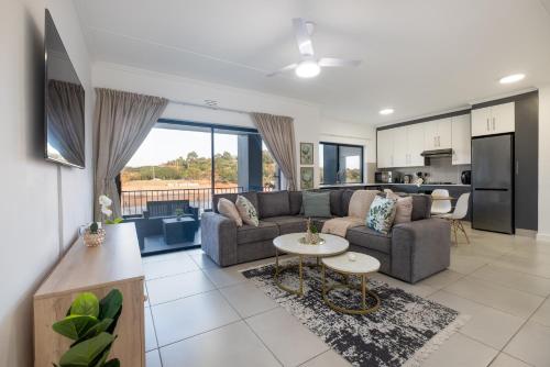 a living room with a couch and a table at Ballito Village Luxury Apartments in Ballito