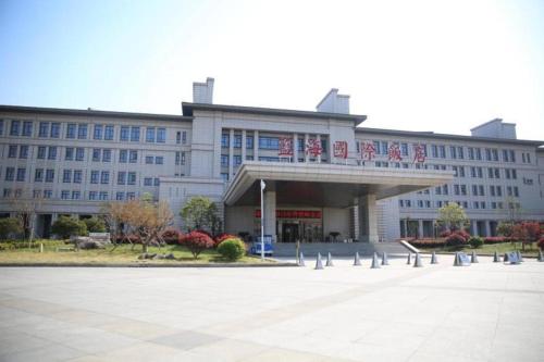 a large white building with a sign on it at Linyi Blue Horizon International Hotel Yi He in Linyi