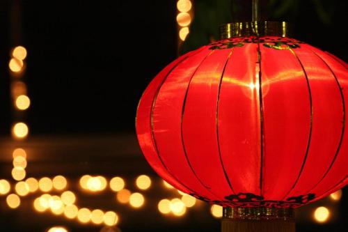 a red lantern with lights in the background at Borneo Hotel in Pontianak
