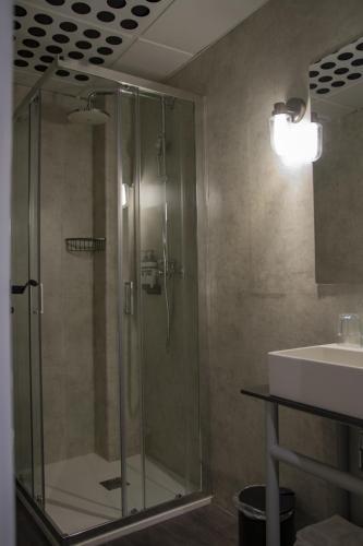 a glass shower in a bathroom with a sink at room00 Valencia Hostel in Valencia