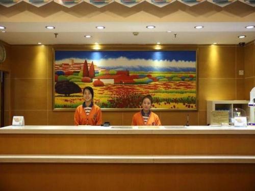 two women standing behind a counter in a restaurant at 7 Days Inn Shenyang Sanhao Street 2nd Hospital of Medicial University in Shenyang