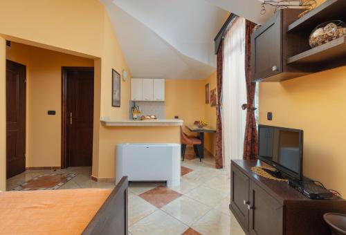 a living room with a tv and a kitchen at Vučković Studios in Kotor