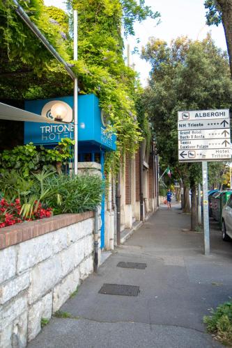 a street sign on the side of a building at Hotel Tritone in Trieste