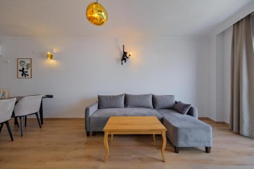 a living room with a blue couch and a table at Körfez Residence in Fethiye