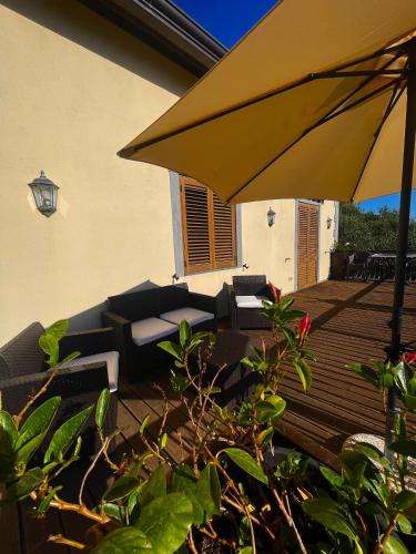 an umbrella and chairs on a wooden deck at Casa Viromar - De Vivo Realty in Meta