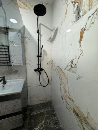 a bathroom with a shower and a sink at Marseille Apartment in Chişinău
