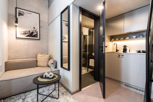 a small living room with a couch and a table at HONEST Karlin in Prague