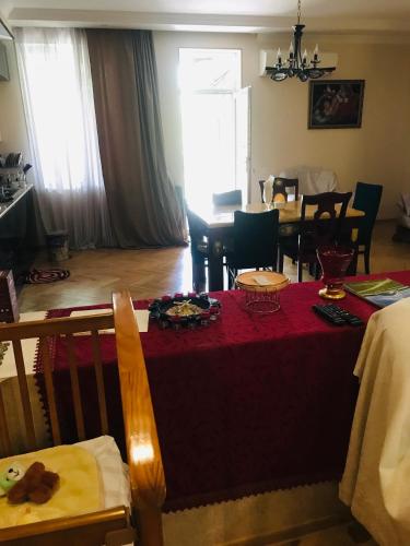 a living room with a table with a red table cloth at gaydi in Gori