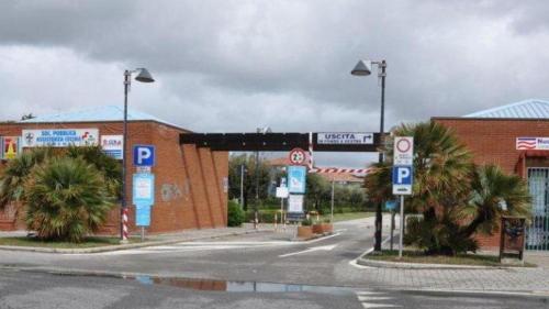 a parking lot with a parking lot sign in front of a building at Zì Maria in Marina di Cecina