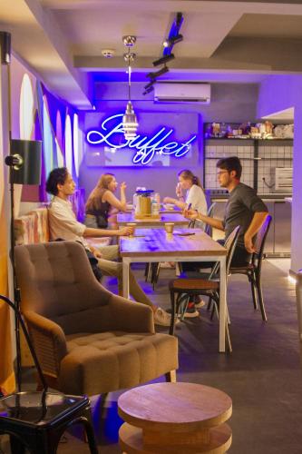 a group of people sitting at a table in a restaurant at room00 Valencia Hostel in Valencia