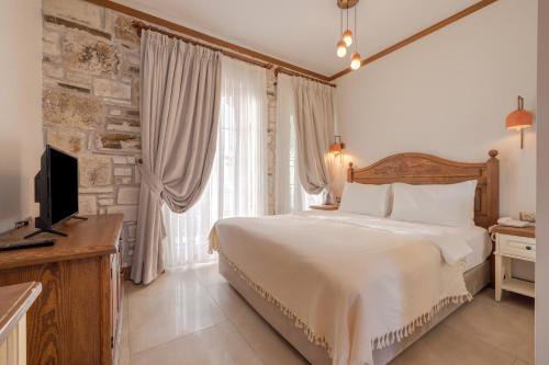Ένα ή περισσότερα κρεβάτια σε δωμάτιο στο Navalia Hotel