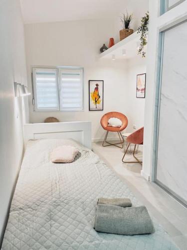 a white bedroom with a large bed in a room at Apartman DE LUX RADIVOJEVIĆ in Sutomore
