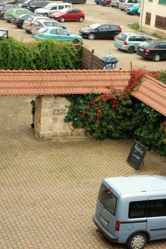 a white van parked in a parking lot at Hotel Abtshof in Halberstadt