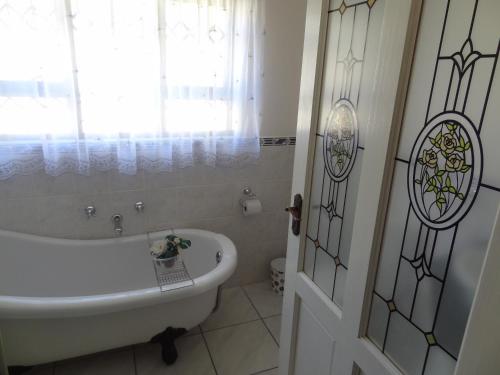 a bathroom with a bath tub and a window at Apartment Chianti's in Port Edward